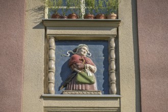 Midwife, relief on old building, former woman's and children's clinic, today St. Marien residential