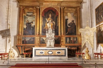 Altar with historical paintings and sacred artworks in a church, Seville