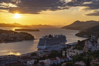Cruise ship Norwegian Escape in the harbour of Dubrovnik at sunset, Croatia, Europe