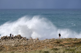 Carrapateira, Algarve, Portugal - Tourists on a viewing platform marvel at the roaring surf and