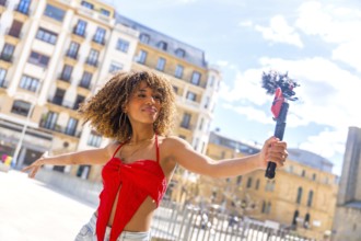 Latin female beauty content creator streaming in the city using phone