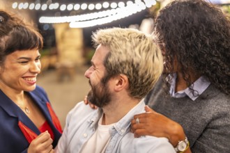 Distracted friends chatting while taking selfies during night party outdoors in the terrace of a