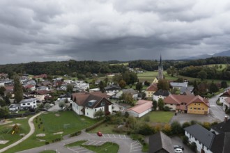 Drone shot, view of village with parish church, Rutzenmoos, Hausruckviertel, Upper Austria,