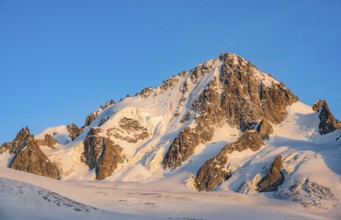 High alpine mountain landscape at sunset, summit of the Aiguille de Chardonnet and Glacier du Tour