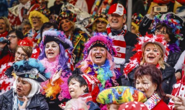 Colourfully costumed carnivalists celebrate carnival in Cologne, on Weiberfastnacht the street