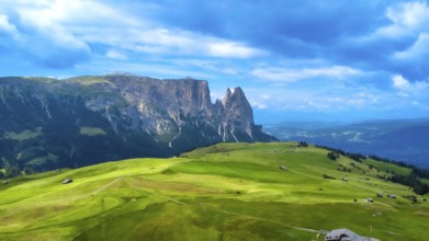 Breathtaking summer landscape featuring lush green meadows, rolling hills, and the majestic peaks