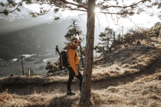 Hiker in the Allgäu at sunset in spring on the Zirmgrat near Pronten in the Allgäu