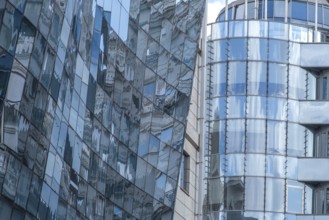 Reflective glass facades of modern office buildings with curved shapes and urban ambience, Skopje,
