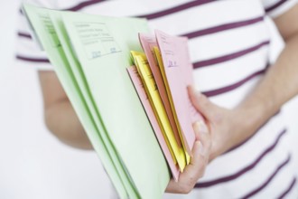 A man holds postal voting documents for the European elections, district council elections and