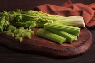 Fresh bunch of celery, top view, no people, on a dark background