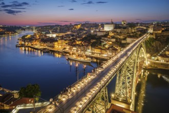 View of illuminated Porto city and Douro river and Dom Luis bridge I from famous tourist viewpoint