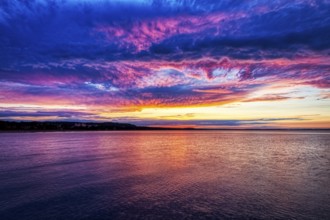 Intense sunset with blue-pink sky over the calm sea, Rügen