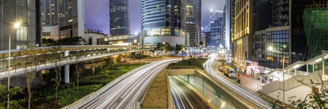 Traffic with streets and skyscrapers in the city of Hong Kong at night Panorama in Hong Kong,