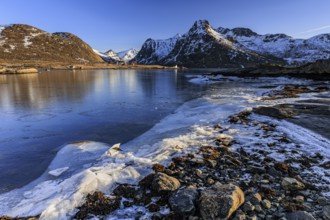 Sunrise, morning light, steep mountains and fjord, ice, winter, Flakstadoya, Lofoten, Norway,