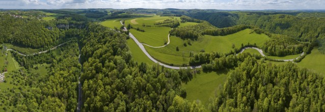 Winding country road through a forest, Swabian Alb in spring, panoramic photo, drone photo,