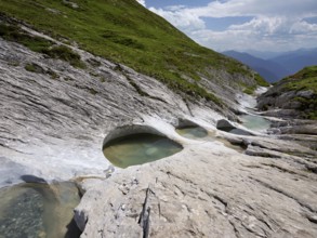 Glacier mill with glacier pots on the Trinser Alp Mora, Trin, Canton Graubünden, Switzerland,