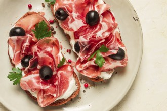 Sandwich with cream cheese, prosciutto with olives, breakfast