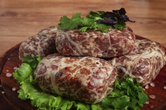 Raw apkhazura, a dish of Georgian cuisine, meat balls, minced meat wrapped in a fat net, seftalia,