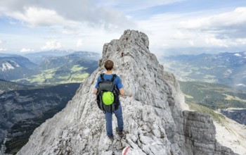 Mountaineer on a narrow rocky ridge, Watzmann crossing to Watzmann Mittelspitze, view of mountain