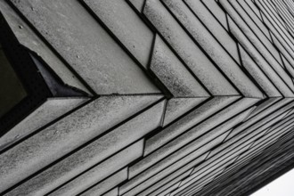 Close-up of an architectural façade with geometric design in grey tones
