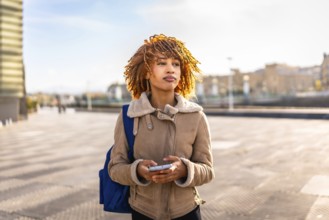 Beauty young latin woman using mobile phone to find a direction in the city