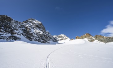 Rocky mountain peak of Piz Kesch and glacier Vadret da Porchabella in winter, mountain landscape,