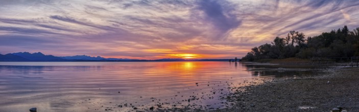 Calm panorama of a lake at sunset with soft colours and cloud formations, Chiemsee