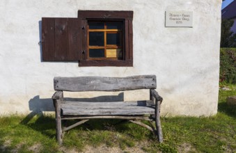 Wooden bench in front of the Stenz poorhouse from 1826, today a pilgrims' hostel on the Via Regia,