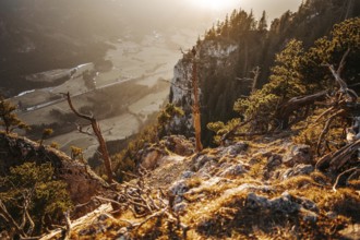 Hiker in the Allgäu at sunset in spring on the Zirmgrat near Pronten in the Allgäu