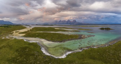 View of mountain range Seven Sisters from Herøy island, light mood with rainbow, Helgeland coast,