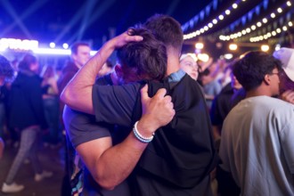A fan of the England team is comforted at the Adidas fan zone at the Bundestag after the final
