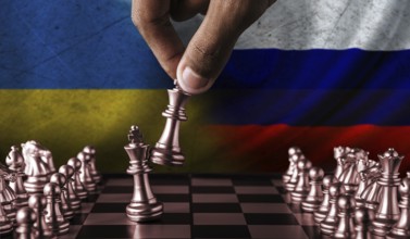 Russia vs Ukraine flag concept on chessboard. Political tension between Russia and Ukraine.