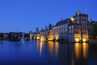 View of the Binnenhof House of Parliament and the Hofvijver lake with downtown skyscrapers in