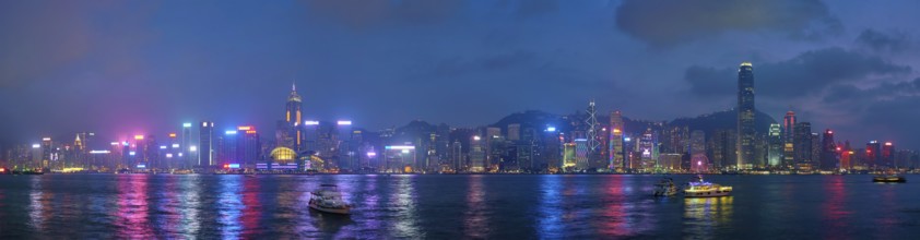Panorama of Hong Kong skyline cityscape downtown skyscrapers over Victoria Harbour in the evening