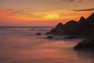 Sunset on Varkala beach popular tourist destination in Kerala state, South India. Long exposure