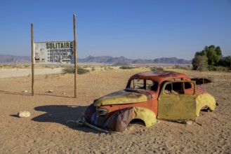 Rusty car wreck in sand, Solitaire, Hardap Region, Namibia, Africa
