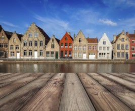Wooden planks table with typical European Europe cityscape view, canal and medieval houses in