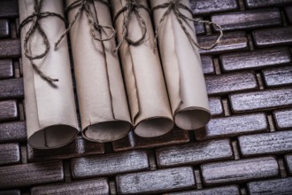 Pile of aged paper rolls on rowing wooden mat