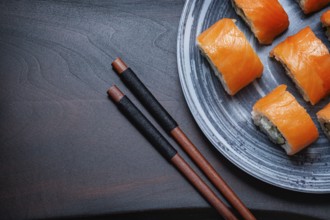 Philadelphia Sushi On Black Wood background