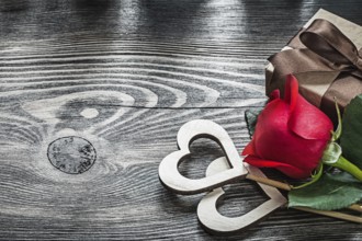 Wooden hearts red rose present box on wood board celebrations concept