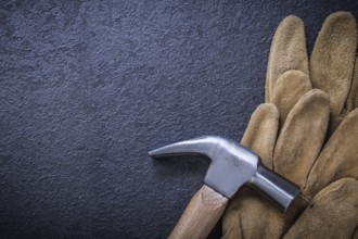 Top view of leather safety gloves claw hammer construction concept