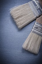 Paintbrushes on wooden board vertical version construction concept