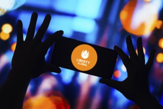 In this photo illustration, the Liberty Global logo is displayed on a smartphone mobile screen
