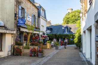 Pont-Aven, France, August 5, 2018: Picturesque street in the walled medieval town. Sunny day