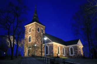 Illuminated Uskela Church, designed by Finnish architect C. L. Engel and built 1832, in winter