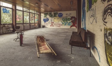 A room in decay with graffiti and damaged furniture, flooded with daylight, Institute of Molecular