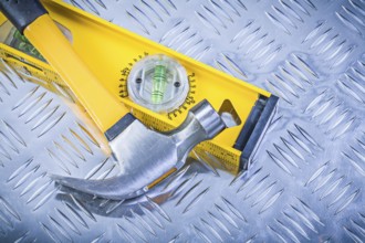 Claw hammer construction level on grooved metal plate