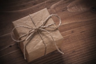 Classical vintage gift box with string bow on wooden board