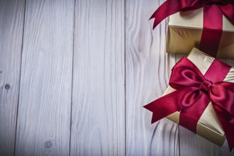 Gift boxes with ribbon on wooden board copy space holidays concept