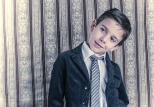 Boy in vintage black suit and tie